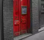 Traditional Chinatown Door in Striking Red Against Monochrome Background